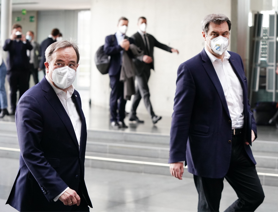 The chairman of the German Christian Democratic Party (CDU), ArminLaschet, left, and the chairman of the German Christian Social Union (CSU), Markus Soeder, right, arrive for a statement folowing a closed meeting of the federal palrliament factions of both partys in Berlin, Germany, Sunday, April 11, 2021. The two party chairmen and German state governors want to become the center-right candidate for the country&#039;s Sept. 26 national election, the German news agency dpa reported Sunday.