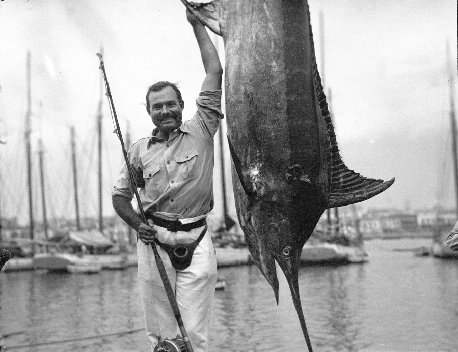In this July 1934 photo provided by the John F. Kennedy Library Foundation from the Ernest Hemingway Collection, Ernest Hemingway poses with a marlin at Havana Harbor, in Key West, Fla. A new three-part documentary about Hemingway, which relied heavily on the archives at the John F. Kennedy Presidential Library and Museum in Boston, debuts April 5, 2021, on PBS. (John F.