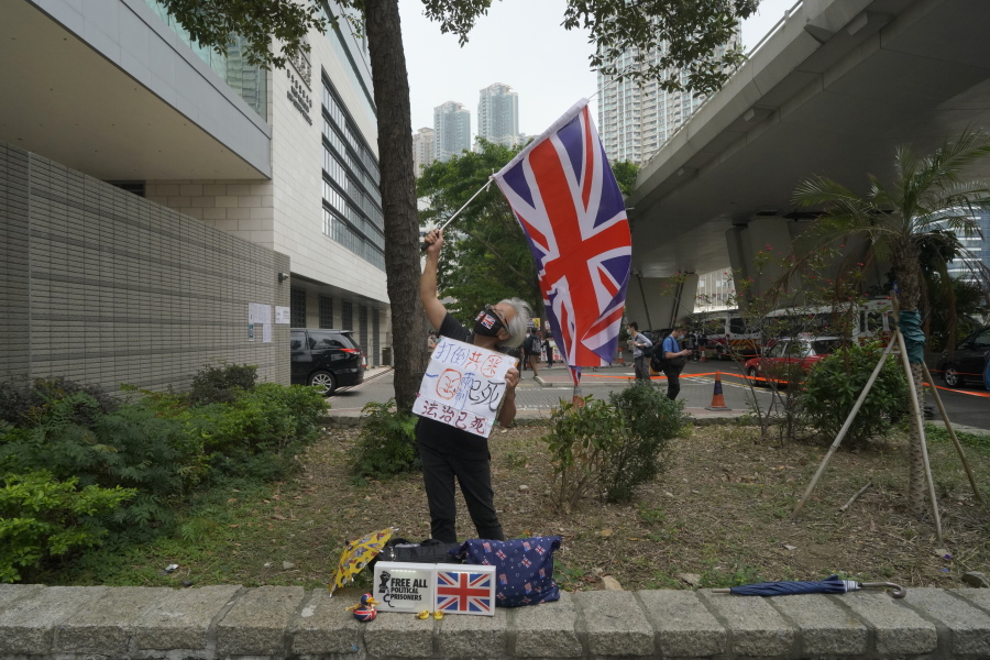 A pro-democracy supporter waves a British flag outside a court in Hong Kong Friday, April 16, 2021.