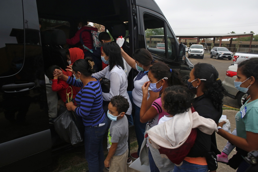 CORRECTS CITY TO MISSION FROM MCALLEN -  Migrants board a van at Our Lady of Guadalupe Catholic Church in Mission, Texas, on Palm Sunday, March 28, 2021. U.S. authorities are releasing migrant families at the border without notices to appear in immigration court and sometimes, without any paperwork at all.