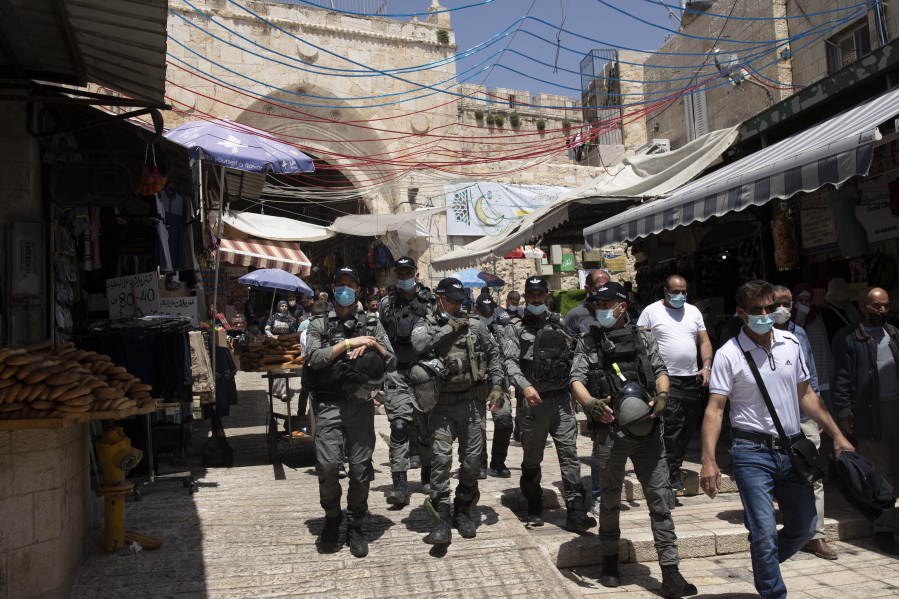 Israeli Border Police patrol the Old City of Jerusalem as worshippers arrive for Friday prayers during the Muslim holy month of Ramadan, on Friday, April 23, 2021.  Israeli police say 44 people were arrested and 20 officers were wounded in a night of chaos in Jerusalem, where security forces separately clashed with Palestinians angry about Ramadan restrictions and Jewish extremists who held an anti-Arab march nearby.