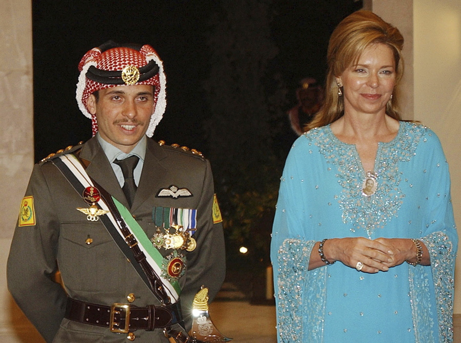 Jordan&#039;s Prince Hamza left, with his mother Queen Noor, right, stand together May 27, 2004, during his wedding ceremony in Amman, Jordan.