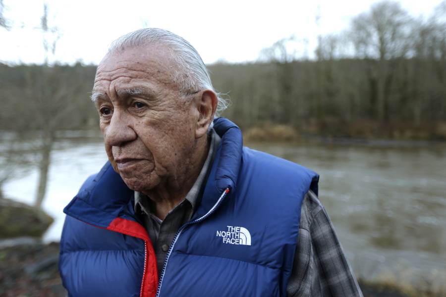 FILE - In this Jan. 13, 2014, file photo, Billy Frank Jr. poses for a photo near Frank's Landing on the Nisqually River in Nisqually, Wash. Gov. Jay Inslee on Wednesday, April 14, 2021, signed a measure that starts the process of honoring the late Frank, a Nisqually tribal member who championed treaty rights and protecting the environment, with a statue at the U.S. Capitol. (AP Photo/Ted S.