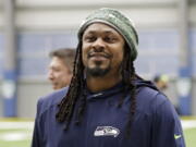 During Marshawn Lynch's 12 NFL seasons he earned a reputation for his fearless style on the field, while remaining one of the league's most reclusive figures off the field. Now the retired running back is lending his voice to try to help members of Black and Hispanic communities make more informed decisions about receiving COVID-19 vaccines.  (AP Photo/Ted S.