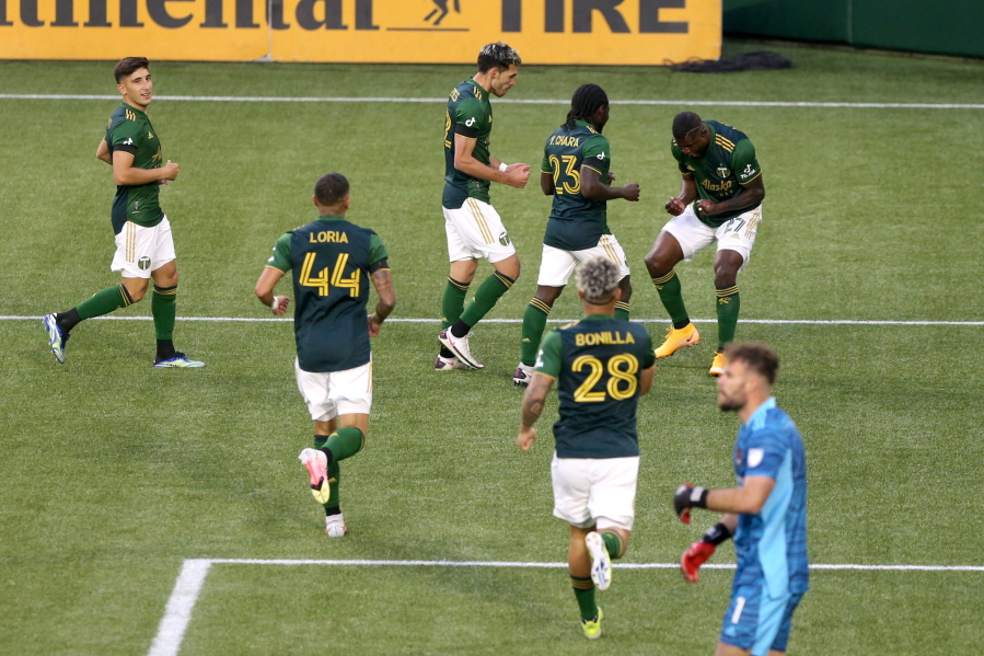 Portland Timbers celebrate a goal by Dairon Asprilla (27) during an MLS soccer match against the Houston Dynamo on Saturday, April 24, 2021, in Portland, Ore.