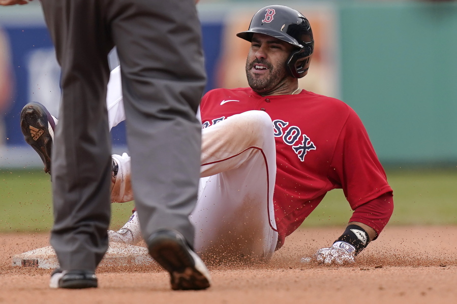 Boston Red Sox's J.D. Martinez is safe at second base after hitting a double off a pitch by Seattle Mariners' Ljay Newsome in the seventh inning of a baseball game, Sunday, April 25, 2021, in Boston.