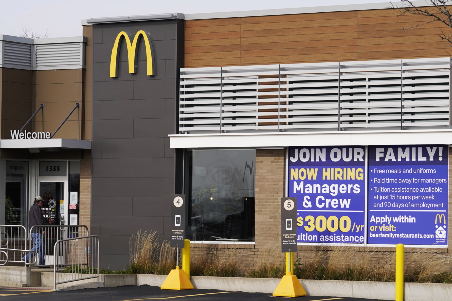 FILE - In this Nov. 19, 2020, file photo, a hiring sign is displayed outside of McDonald's in Buffalo Grove, Ill. On Wednesday, April 14, 2021, McDonald's said the company will mandate worker training to combat harassment, discrimination and violence in its restaurants worldwide starting in 2022.  (AP Photo/Nam Y.