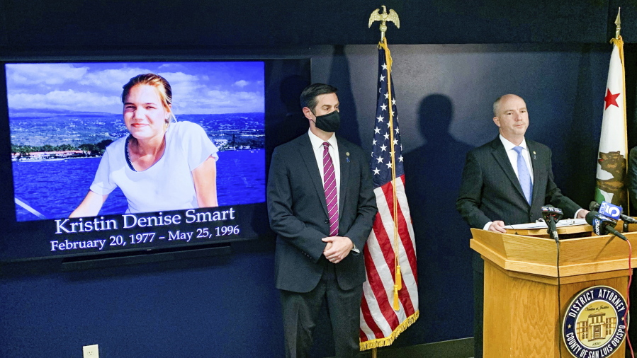 San Luis Obispo District Attorney Dan Dow announces a murder charge is filed against Paul Flores in the Kristin Smart case, as Deputy District Attorney Chris Peuvrelle listens at left, during a news conference, Wednesday, April 14, 2021, in Arroyo Grande, Calif. Smart, a missing California college who was killed in 1996 during an attempted rape by a fellow student, and the suspect's father helped hide her body, the San Luis Obispo County district attorney said Wednesday.
