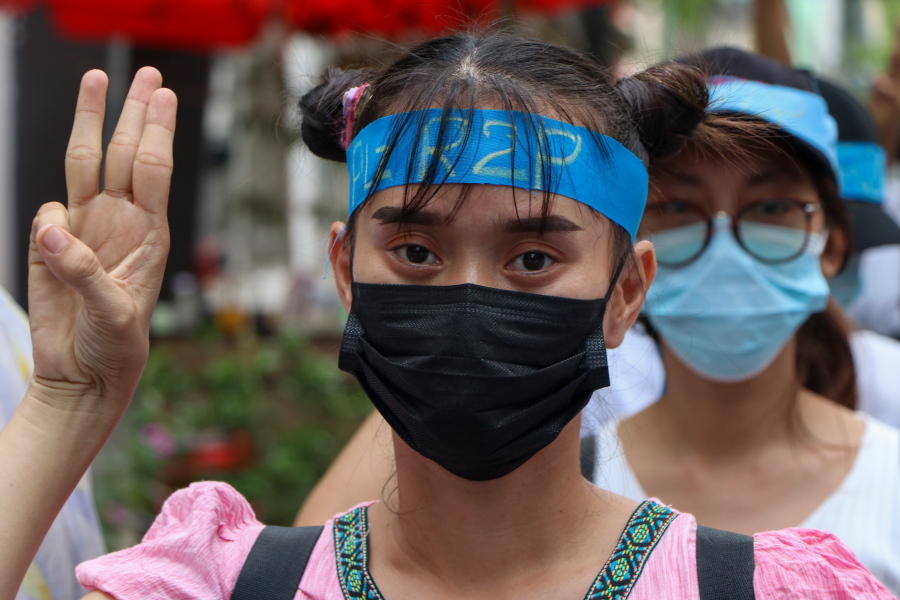 An anti-coup protester flashes the three-fingered salute while wearing a headband that reads R2P, which means Responsibility to Protect, during a gathering in Ahlone township in Yangon, Myanmar Monday, April 12, 2021. The protesters have called for foreign intervention to aid them under the doctrine of Responsibility to Protect, or R2P, devised to deal with matters such as genocide, war crimes, ethnic cleansing and crimes against humanity.