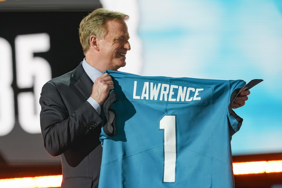 NFL Commissioner Roger Goodell holds a Jacksonville Jaguars jersey as he announces that the Jaguars had chosen Clemson quarterback Trevor Lawrence with the first pick in the NFL football draft, Thursday April 29, 2021, in Cleveland.