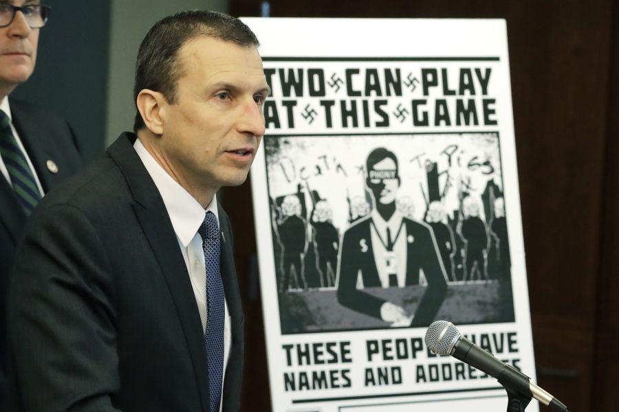 FILE - In this Feb. 26, 2020, file photo, Raymond Duda, FBI Special Agent in Charge in Seattle, speaks as he stands next to a poster that was mailed earlier in the year to the home of Chris Ingalls, an investigative reporter with KING-TV during a news conference in Seattle. A federal judge declined to impose prison time Wednesday, March 31, 2021, on a former member of a neo-Nazi ring that made threats against journalists, finding that the 21-year-old, who concealed his transgender identity from his co-conspirators, had already suffered enough in his young life. (AP Photo/Ted S.