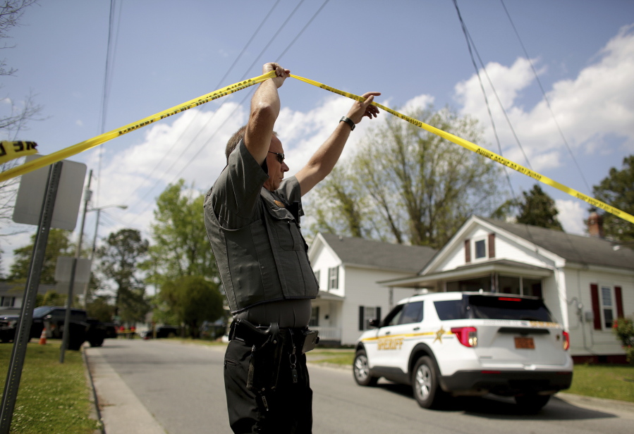 Law enforcement investigate the scene of a shooting, Wednesday, April 21, 2021 in Elizabeth City, N.C. At least one law enforcement officer with a sheriff's department in North Carolina shot and killed a man while executing a search warrant Wednesday, the sheriff's office said.  (Stephen M.