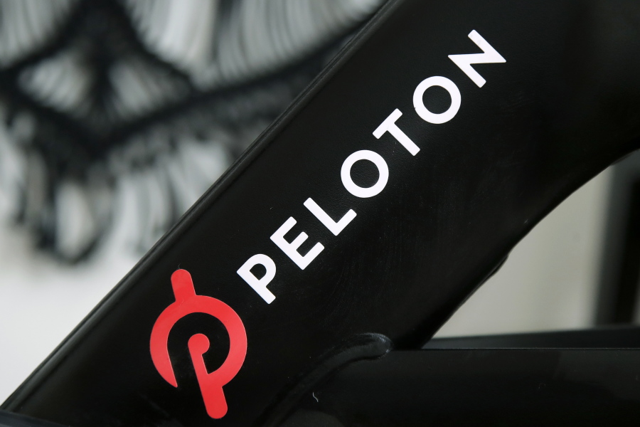 FILE - This Nov. 19, 2019 file photo shows a Peloton logo on the company's stationary bicycle in San Francisco.   Safety regulators are warning people with kids and pets to immediately stop using a treadmill made by Peloton after one child died and nearly 40 others were injured. The U.S. Consumer Product Safety Commission said Saturday, April 17, 2021, that it received reports of children and a pet being pulled, pinned and entrapped under the rear roller of the treadmill, leading to fractures, scrapes and the death of one child.