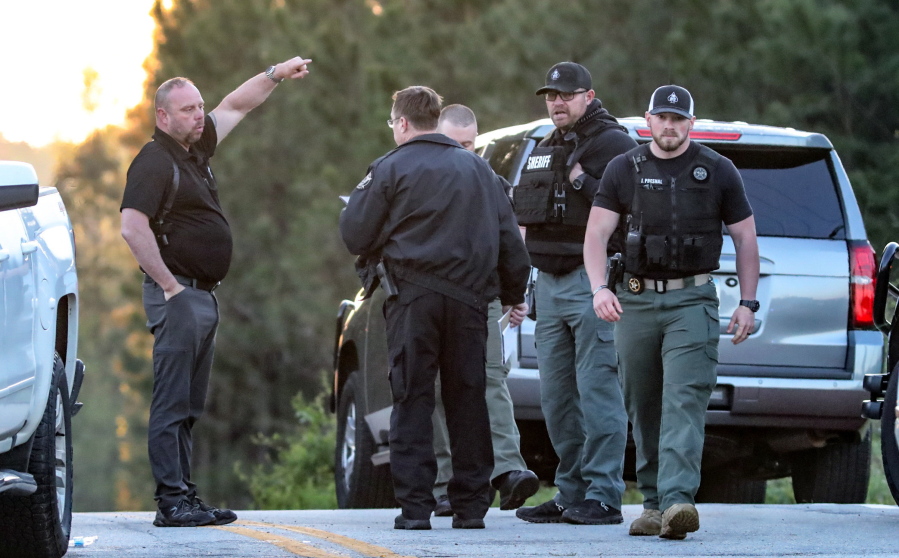Law enforcement work the scene scene following a police chase Monday, April 12, 2021, in Carroll County, Ga. Georgia authorities say multiple officers were injured when the passenger of a car shot them during a police chase that ended with one suspect killed and the other arrested.