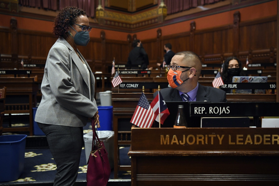 Connecticut House Majority Leader Jason Rojas, D-East Hartford, right, speaks with State Rep. Toni Walker, D-New Haven, left, during session at the State Capitol in Hartford, Conn., on Monday, April 19, 2021. In July 2020 after George Floyd was killed in Minneapolis, Black and Latino members of the Connecticut General Assembly worked to enact sweeping changes to policing in the state, and since, have continue to flex their collective muscles.