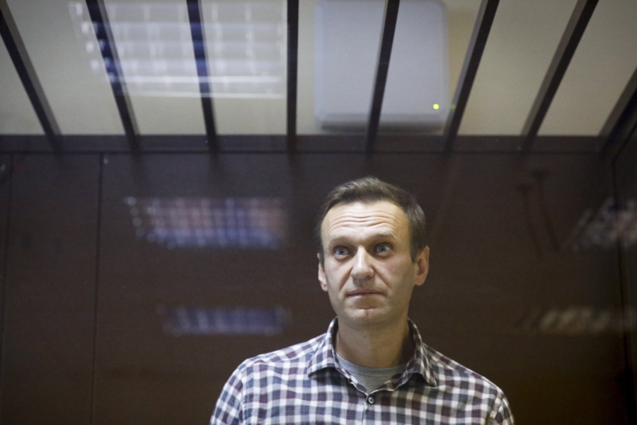 FILE - In this Feb. 20, 2021, file photo, Russian opposition leader Alexei Navalny stands in a cage in the Babuskinsky District Court in Moscow, Russia. Navalny, who is in the third week of a hunger strike, will be admitted to a hospital in another prison, the Russian state penitentiary service said Monday, April 19, after the politician's doctor said he could be near death.