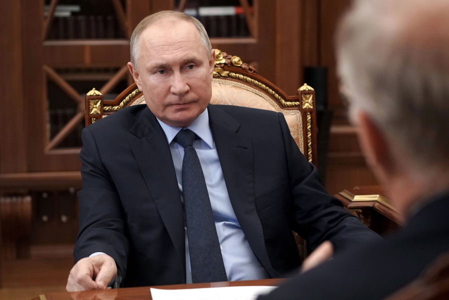 Russian President Vladimir Putin listens to General Director of the Russian Direct Investment Fund Krill Dmitriev at the Kremlin in Moscow, Russia, Friday, April 2, 2021.