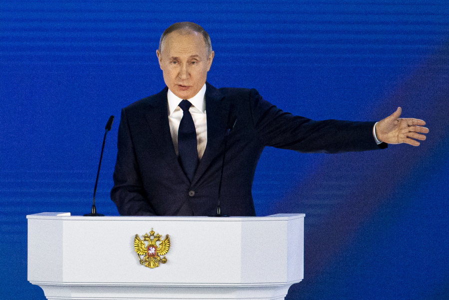 Russian President Vladimir Putin gestures as he gives his annual state of the nation address in Manezh, Moscow, Russia, Wednesday, April 21, 2021. Putin's state-of-the-nation speech comes amid a new surge in tensions with the West over a Russian troop buildup near the border with Ukraine and a hunger strike by jailed Russian opposition leader Alexei Navalny protesting a lack of adequate medical treatment in prison.