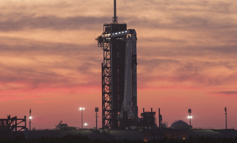 In this Wednesday, April 21, 2021 photo provided by NASA, a SpaceX Falcon 9 rocket with the company's Crew Dragon spacecraft onboard sits on the launch pad at Launch Complex 39A at NASA's Kennedy Space Center in Cape Canaveral, Fla., at sunset. NASA astronauts Shane Kimbrough and Megan McArthur, European Space Agency astronaut Thomas Pesquet, and Japan Aerospace Exploration Agency astronaut Akihiko Hoshide are scheduled for a Friday launch.