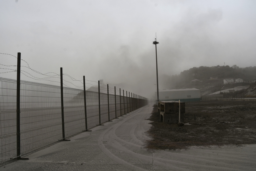 A road is blanketed in volcanic ash at the international airport in Kingstown, on the eastern Caribbean island of St. Vincent, Saturday, April 10, 2021 due to the eruption of La Soufriere volcano.
