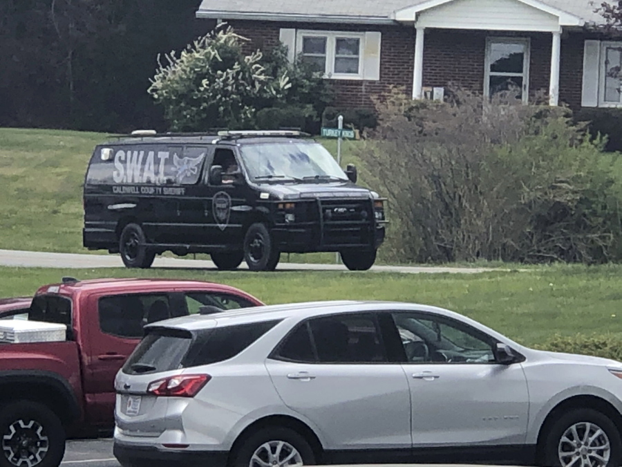 In this photo provided by WJZY, a tactical van from Caldwell County, North Carolina, sits on stand-by at a staging area in Boone, N.C., on Wednesday, April 28, 2021. Law enforcement agencies responded to a standoff in Boone in which two Watauga County sheriff's deputies were shot and wounded.