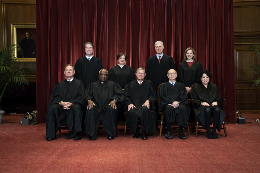 FILE - In this April 23, 2021, file photo members of the Supreme Court pose for a group photo at the Supreme Court in Washington. Seated from left are Associate Justice Samuel Alito, Associate Justice Clarence Thomas, Chief Justice John Roberts, Associate Justice Stephen Breyer and Associate Justice Sonia Sotomayor, Standing from left are Associate Justice Brett Kavanaugh, Associate Justice Elena Kagan, Associate Justice Neil Gorsuch and Associate Justice Amy Coney Barrett. Before the Supreme Court this is week is an argument over whether public schools can discipline students over something they say off-campus.