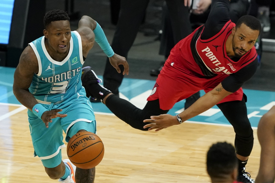 Charlotte Hornets guard Terry Rozier drives past Portland Trail Blazers forward Norman Powell during the second half in an NBA basketball game on Sunday, April 18, 2021, in Charlotte, N.C.