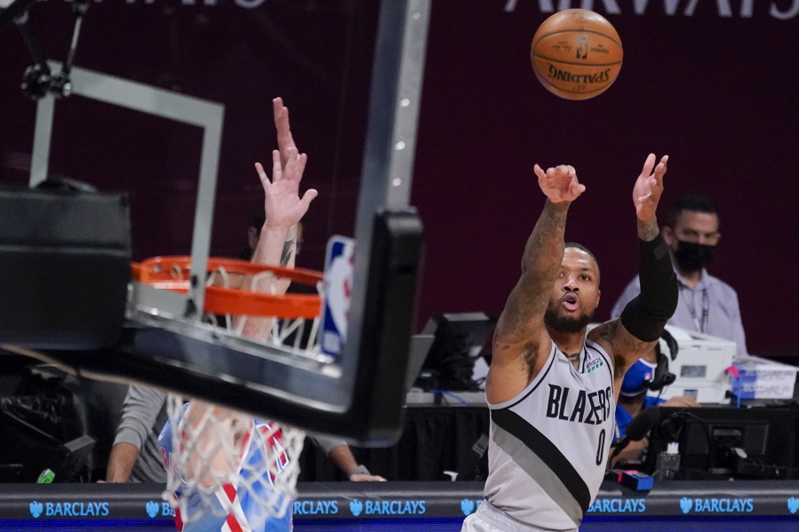 Portland Trail Blazers guard Damian Lillard (0) shoots a three-point goal during the second half of an NBA basketball game against the Brooklyn Nets, Friday, April 30, 2021, in New York.