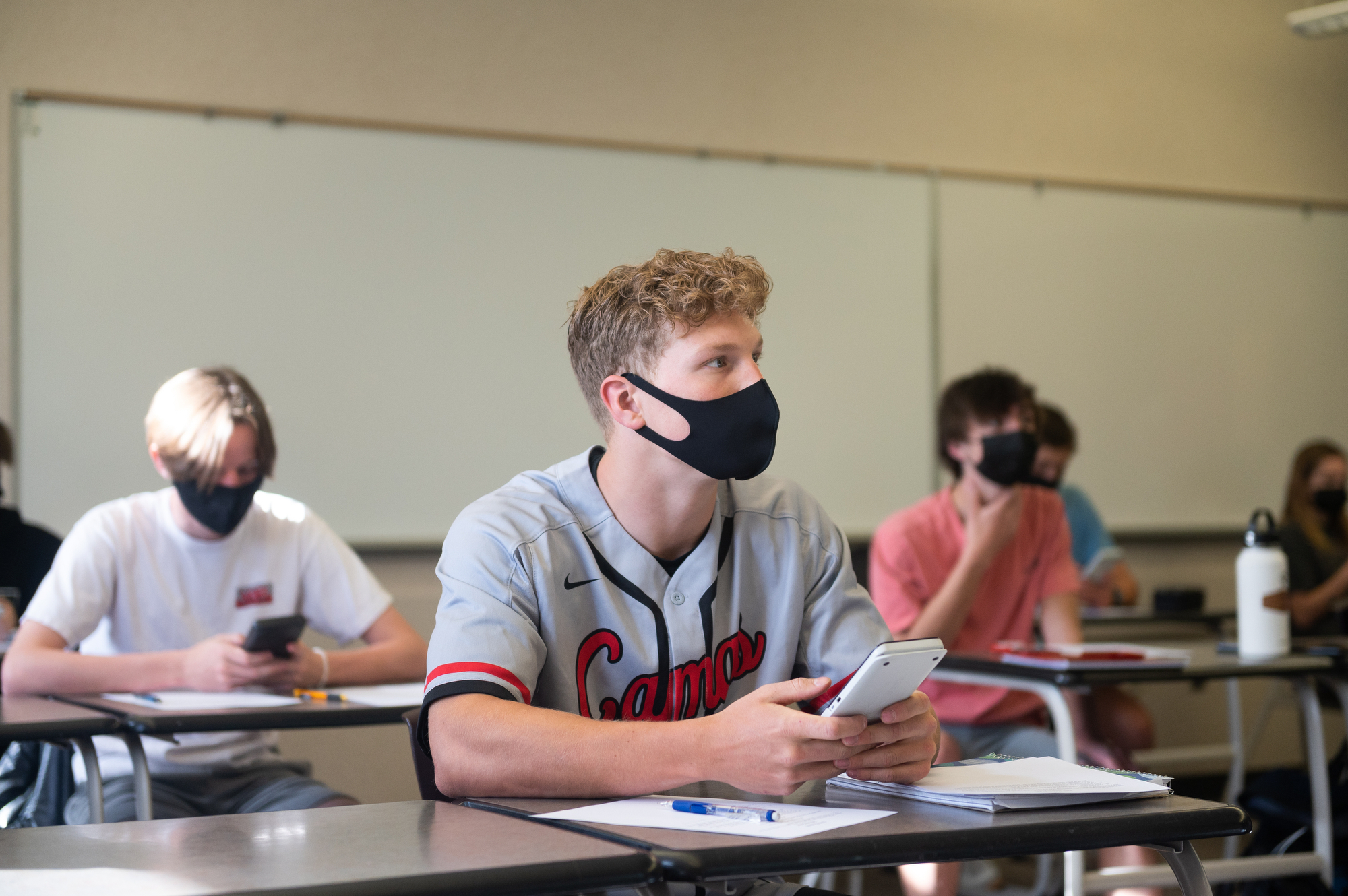 Lucas Warner, center, focusses during a calculus class taught by Craig Hardin at Camas High School on Monday. Camas returned to four-day-a-week in-person instruction on Monday.