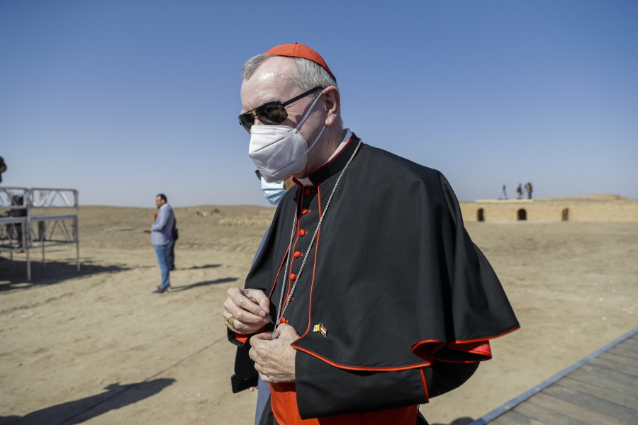 FILE - In this file photo taken on March 6, 2021, Vatican Secretary of State Cardinal Pietro Parolin arrives ahead of an interreligious meeting with Pope Francis near the archaeological area of the Sumerian city-state of Ur, 20 kilometers south-west of Nasiriyah, Iraq. The Vatican No. 2 is skipping a planned trip to Venezuela this week because of the coronavirus pandemic. Cardinal Pietro Parolin, the Vatican's former ambassador to Caracas, had planned to celebrate the April 30 beatification of Jose Gregorio Hernandez, dubbed the "doctor of the poor." The Vatican said Wednesday that due to issues linked to the pandemic, Parolin wouldn't make the trip.
