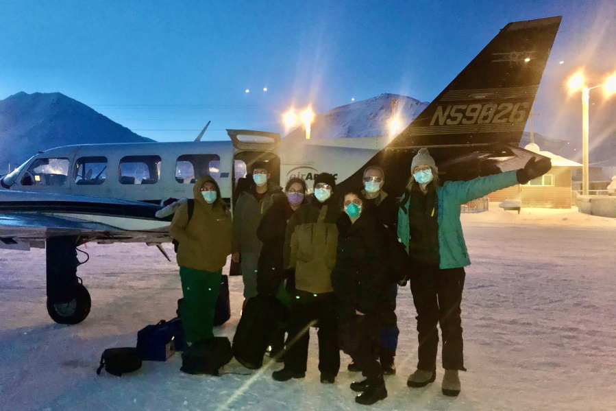 In this undated photo, provided by the Tanana Chiefs Conference, shows a team from the tribal health organization posing outside a plane before leaving for a rural vaccination clinic in Anaktuvuk Pass, Alaska. Some of Alaska's highest vaccination rates among those 16 or older have been in some of its remotest, hardest-to-access communities, where the toll of past flu or tuberculosis outbreaks hasn't been forgotten.