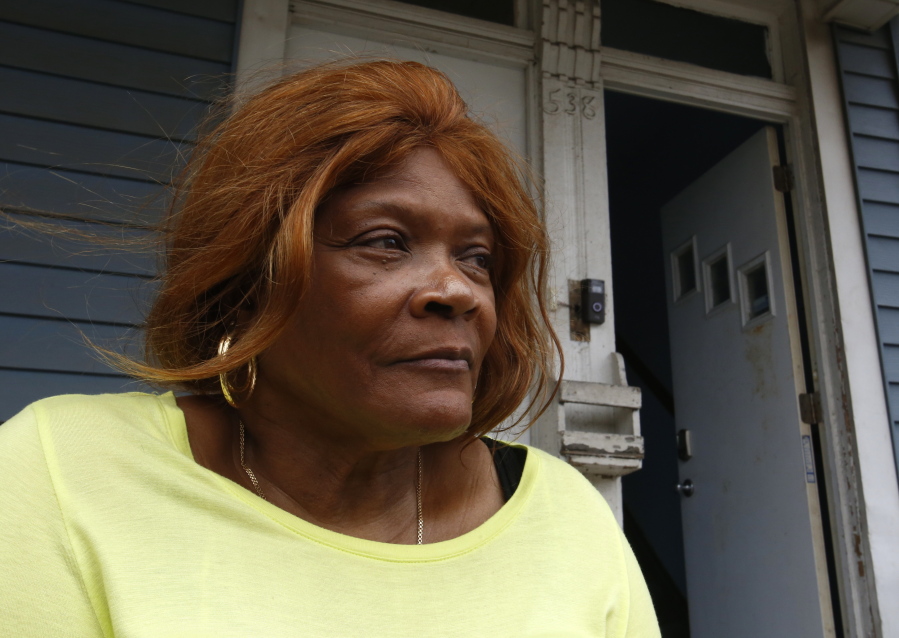 Dianne Green sits on the porch of her home in Chicago on Wednesday, March 24, 2021. Green, a retiree and cancer survivor, said she struggled with loneliness after several family members died in 2019 and early 2020. Then the pandemic hit. She credits a "friendly caller" from Rush University Medical Center with pulling her out of the depths of despair. Even before the pandemic, a survey found that 61 percent of American adults said they were lonely. A year of added isolation highlighted a problem that health officials say is as harmful as obesity and smoking.
