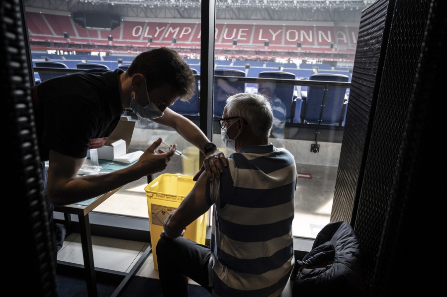 Patients receive an injection of the Moderna Covid-19 vaccine on the opening day of a mass vaccination centre set up in the Olympique Lyonnais soccer Stadium, in Decines-Charpieu, Saturday, April 3, 2021.
