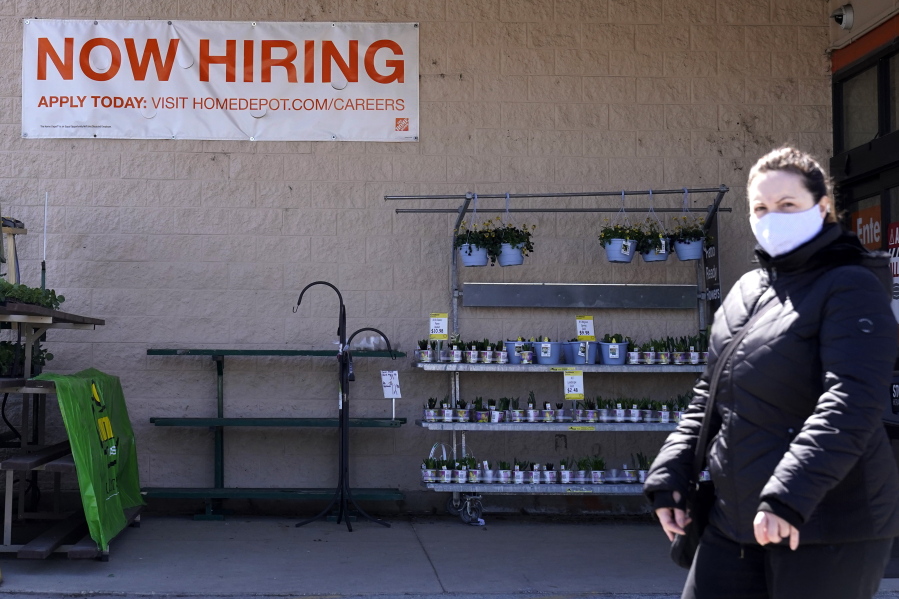 A hiring sign is seen outside home improvement store in Mount Prospect, Ill., Friday, April 2, 2021.  The pace of job openings reached the highest level on record in February, a harbinger of healthy hiring and a hopeful sign for those looking for work.  (AP Photo/Nam Y.