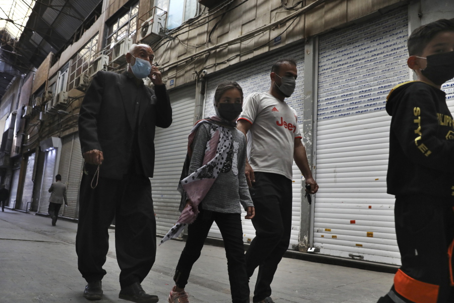 People walk through closed Tehran&#039;s Grand Bazaar, Iran, Saturday, April 10, 2021. Iran on Saturday imposed partial lockdown on businesses in major shopping centers as well as intercity travels through personal cars in major cities including capital Tehran as it struggles with the worst outbreak of the coronavirus in the Mideast region.