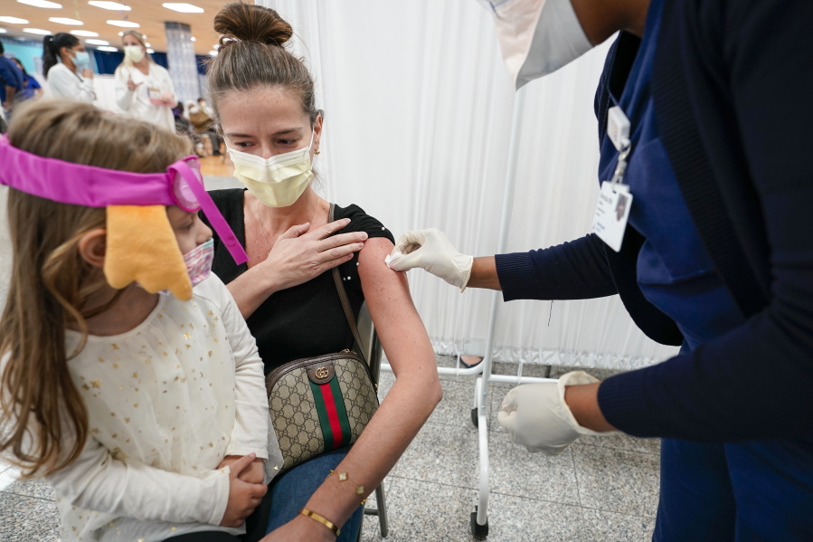 Mosque member Asie Late&#039;s granddaughter Emma watches as a Northwell Health registered nurse inoculates her with the Johnson &amp; Johnson COVID-19 vaccine at a pop up vaccination site inside the Albanian Islamic Cultural Center, Thursday, April 8, 2021, in the Staten Island borough of New York.