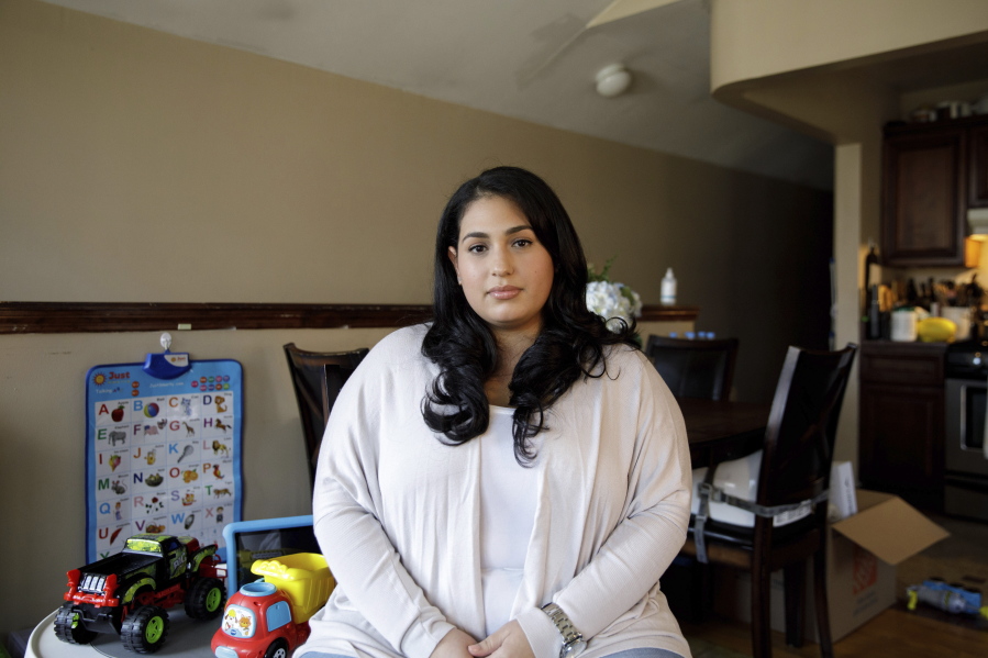 Priscilla Medina poses for a portrait in her home in Queens in New York on Wednesday, April 7, 2021. After being exposed and suffering severe symptoms from COVID-19, If Medina had gotten COVID-19 a year earlier, she would have had no treatments proven safe and effective to try. But when the 30-year-old nurse arrived at a Long Island hospital in March 2021, so short of breath she could barely talk, doctors knew just what to do. They quickly arranged for her to get a novel drug that supplies virus-blocking antibodies, and "by the next day I was able to get up and move around," she said. After two days, "I really started turning the corner.