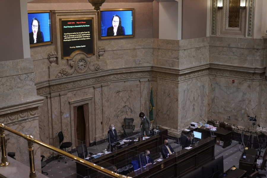 State Rep. April Berg, D-Mill Creek, is displayed on video monitors as she speaks remotely during a session of the House, Wednesday, April 21, 2021, at the Capitol in Olympia Wash.  (AP Photo/Ted S.