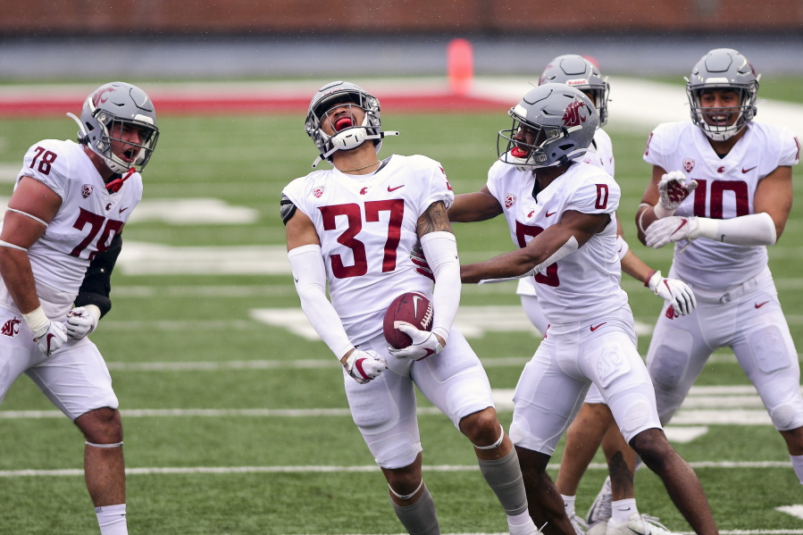 Washington State linebacker Justus Rogers (37) celebrates with with defensive back Jaylen Watson (0) and others after intercepting a pass by quarterback Jarrett Guarantano during the first quarter of the NCAA college football team's spring game Saturday, April 24, 2021, in Pullman, Wash.