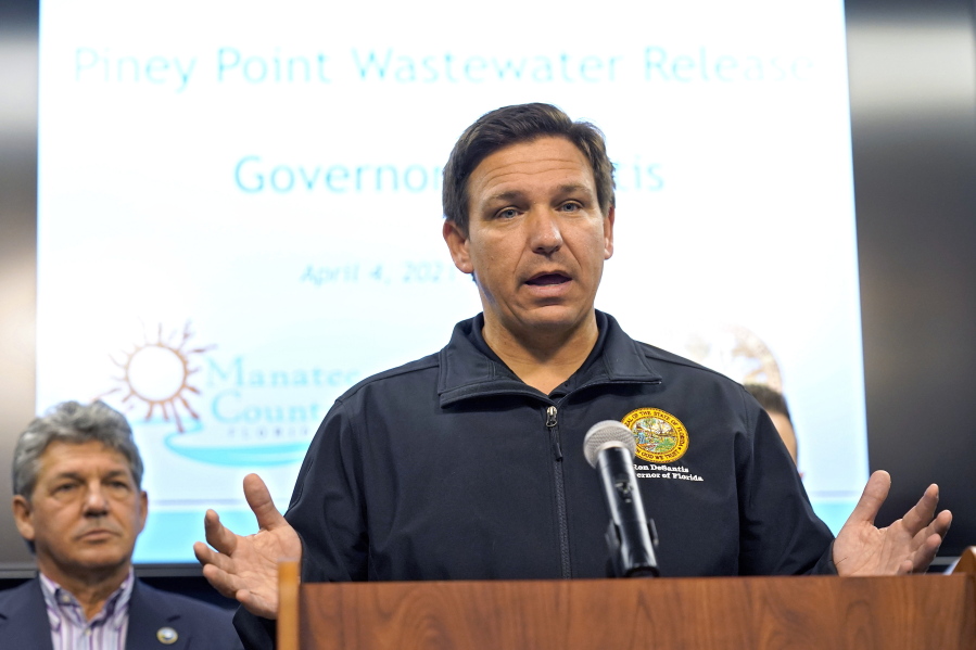 Florida Gov. Ron DeSantis gestures during a news conference Sunday, April 4, 2021, at the Manatee County Emergency Management office in Palmetto, Fla. DeSantis declared a state of emergency Saturday after a leak at a large pond of wastewater threatened to flood roads and burst a system that stores polluted water.