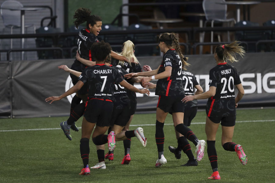 Portland Thorns players celebrate a goal scored by Portland's Rocky Rodriguez (11), left, against Kansas City during an NWSL Challenge Cup soccer match, Friday, April 9, 2021, in Portland, Ore.