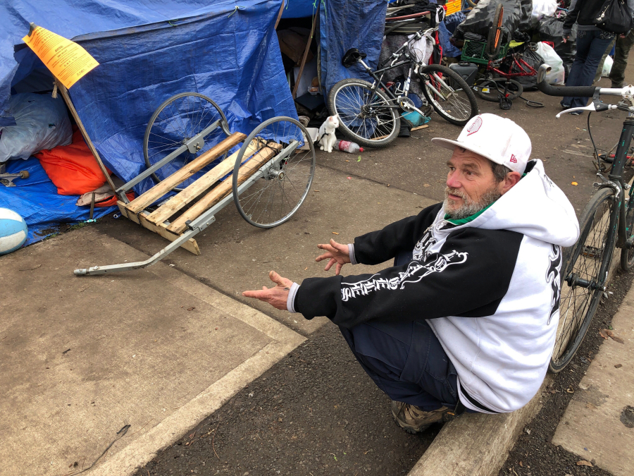 James Wilbur speaks to a reporter Dec. 17, 2019, in Salem, Ore., after he and other homeless people camping on a street were notified that they must leave. Oregon lawmakers passed a bill that will make it easier and quicker for communities to create emergency shelters and temporary housing.