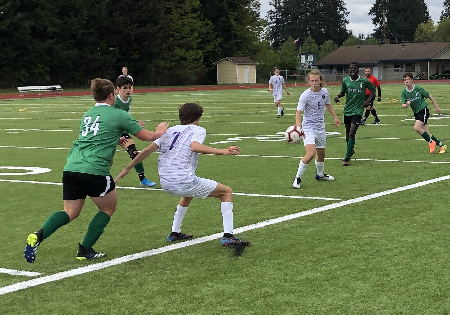 Columbia River's Alexander Harris (7) shields off a Tumwater defender after a pass from teammate Logan Simmons (9) during the 2A boys soccer district championship match on Saturday at Tumwater High School.
