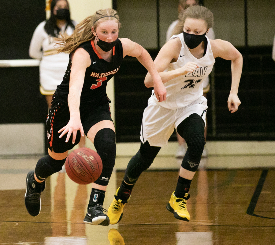 Washougal's Savea Mansfield (3) dribbles down the court while being defended by Hudson's Bay's Paytin Ballard (21) during the third quarter of a girl's high school basketball game at Hudson's Bay High School on Wednesday.