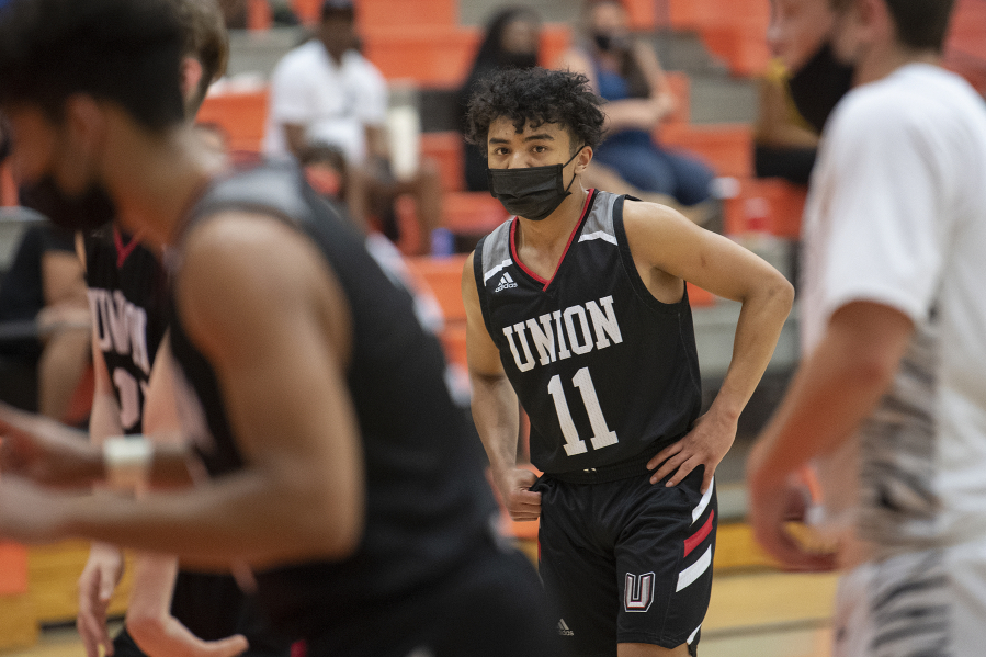 Union's Izaiah Vongnath (center) joins teammates in the second quarter against Battle Ground at Battle Ground High School on Tuesday night, May 11, 2021.
