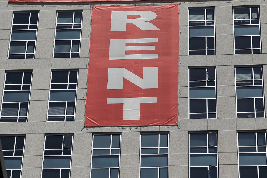 A large "rent" banner is posted on the side of an apartment building in San Francisco in 2012. President Joe Biden wants to add some 200,000 Section 8 vouchers but housing advocates and critics say the rental assistance program is flawed and allows discrimination.