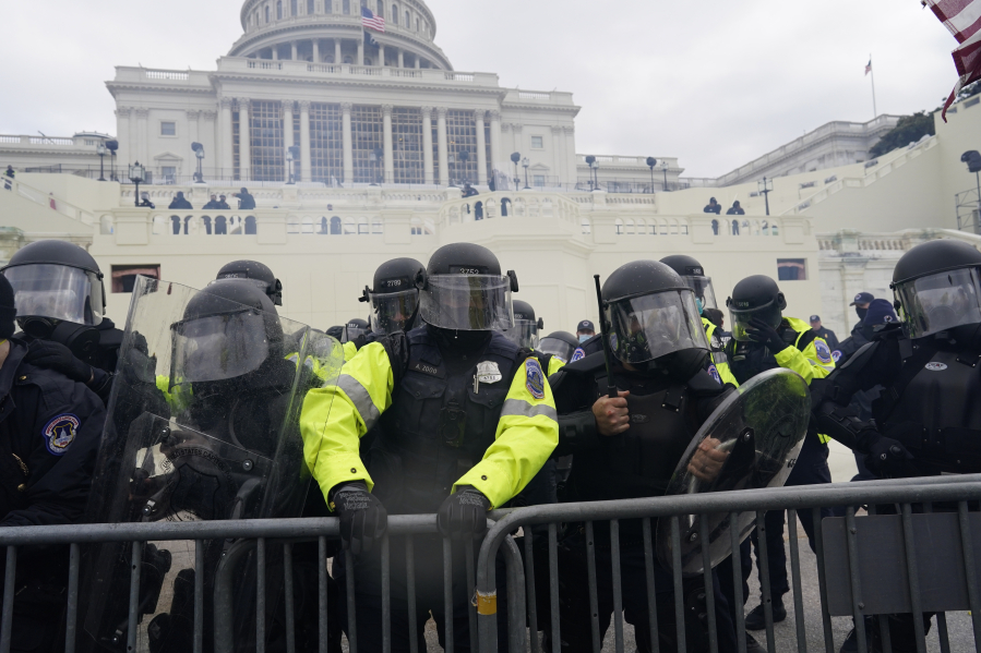 Police try to hold back protesters who gather to storm the Capitol and halt a joint session of the 117th Congress on Wednesday, Jan. 6, 2021, in Washington, D.C.
