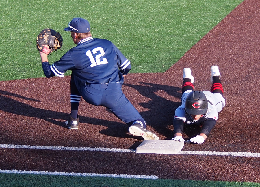 Skyview first baseman Brock Blakley (12) takes a throw as Camas baserunner Zach Blair safely dives back to the bag.