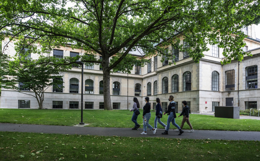 Visitors to the University of Washington campus walk past Denny Hall in Seattle on July 2.