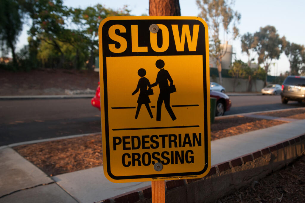 A "Slow Pedestrian Crossing" sign in Los Angeles, California. Advocates say safety improvements, such as adding traffic signals and medians to protect pedestrians, should be a bigger part of President Joe Biden’s infrastructure plan.